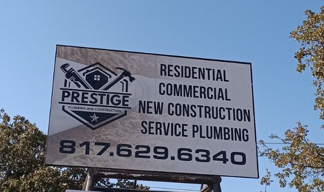 Billboard for a local plumber in Weatherford TX advertising Prestige Plumbing and Construction residential and commercial plumbing services.