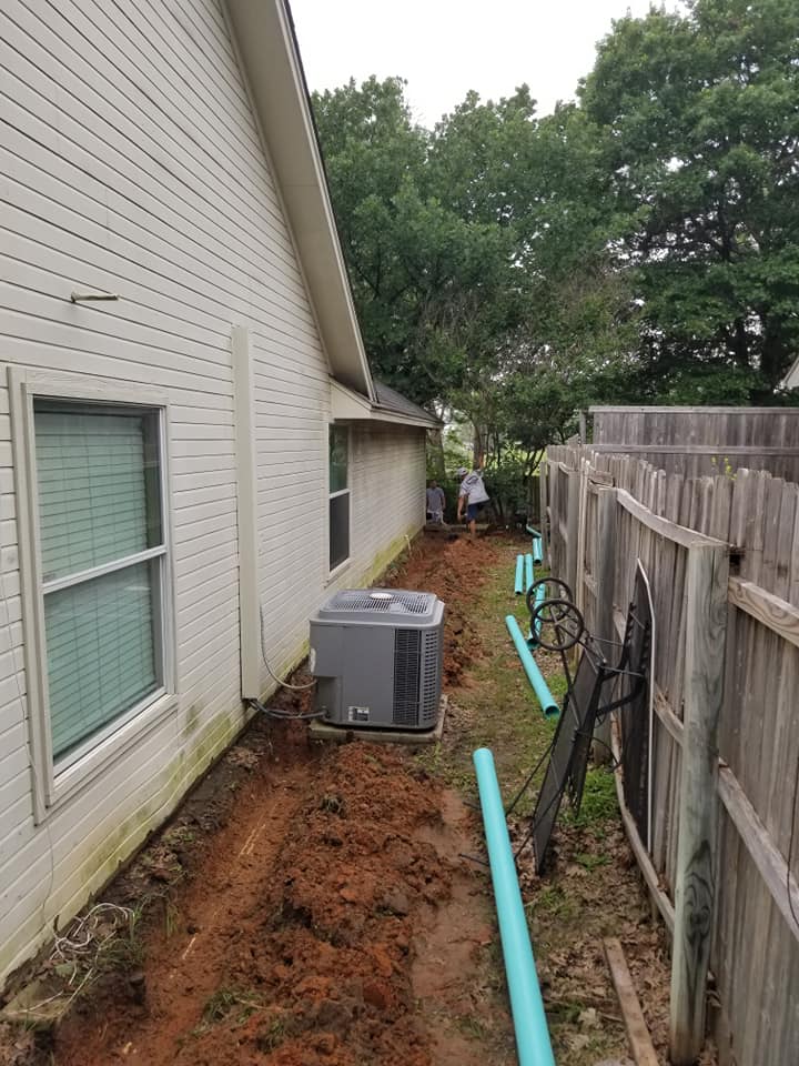 Prestige Plumbing & Construction performing repiping in Weatherford, Texas with exposed yard trenches and new piping installation along the side of a home.