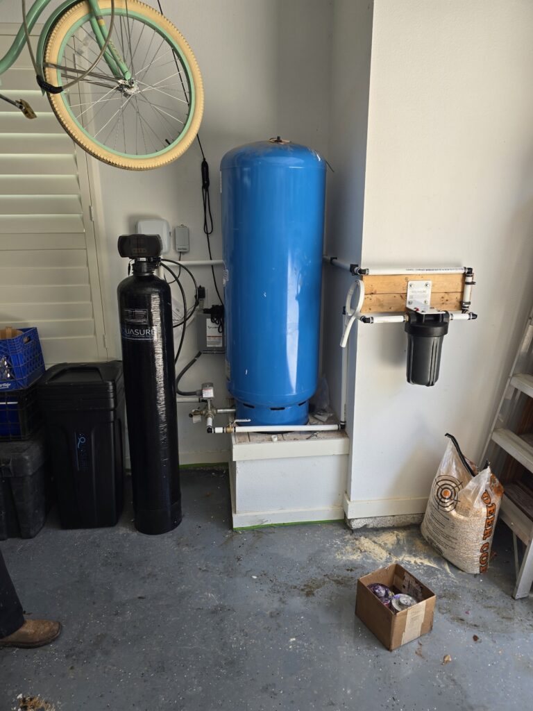 Residential water treatment system with filtration and pressure tank installed by Prestige Plumbing in Weatherford, TX.